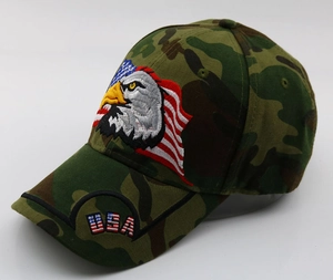 Detailed view of eagle and USA flag embroidery on jungle camo baseball cap