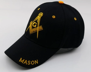 Detail of yellow Mason embroidery with G letter on black baseball cap cotton fabric