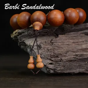 Barbie Sandalwood Buddhist beads bracelet with carved gourd charms on rustic wood