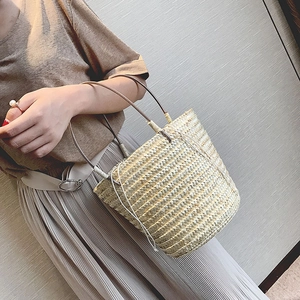 Handmade bohemian straw bucket bag with drawstring liner for summer beach vacation