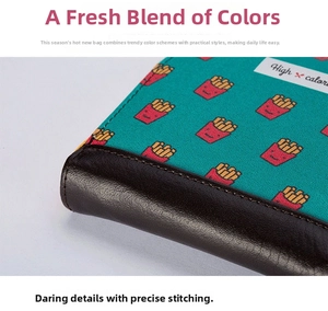 Detail of teal canvas coin purse with cartoon fries embroidery and premium leather trim