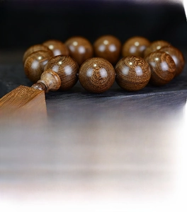 Macro view of Sandalwood beads showing natural black and gold grain textures