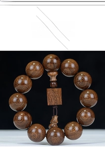 Macro detail of sandalwood Buddhist prayer beads showing rich natural wood grain texture