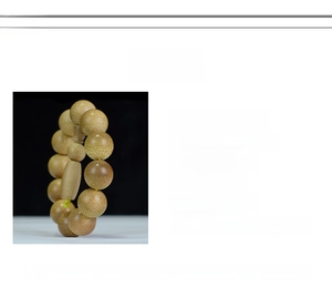 Close-up of 20mm natural golden silk bamboo prayer beads with detailed texture and grain
