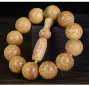 Detailed close-up of high-density dragon blood bamboo beads with natural snake-wood grain