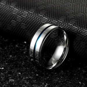 Detailed view of silver stainless steel ring featuring a sleek blue center groove inlay