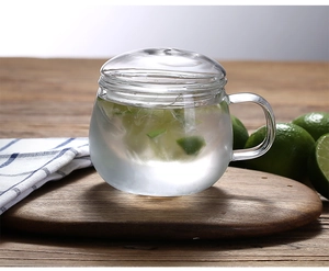 Detail of heat-resistant borosilicate glass tea cup with lid and fresh lime slices inside
