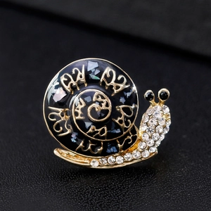 Vintage cartoon snail brooch in gold metal with black enamel shell and clear rhinestones