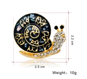 Detailed size view of a vintage snail brooch with black shell and crystal pave setting