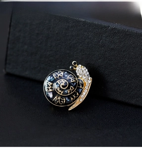 Detailed macro shot of vintage snail brooch with blue shell and pavé rhinestones