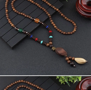 Detailed close-up of ethnic wooden bead necklace with Fu character and bodhi pendant