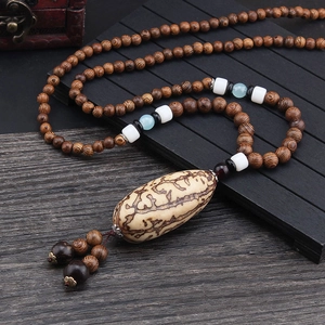 Ethnic style necklace with brown wooden beads and large patterned oval pendant charm