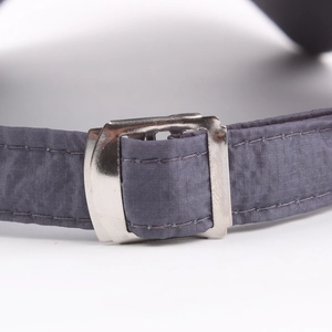 Macro detail of breathable quick-dry baseball cap with adjustable metal buckle and grey fabric