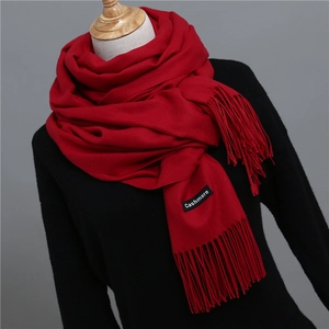 Close-up of classic red cashmere scarf with detailed tassel fringe and texture