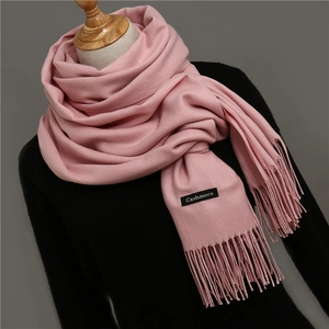 Detail shot of pink cashmere scarf featuring soft texture and elegant tassel edges