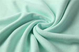 Macro shot of soft mint green pashmina fabric texture and delicate brushed fibers