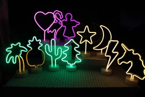 Collection of neon LED mood lights in flamingo and unicorn shapes with round bases