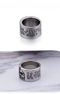 Macro detail of punk pirate skull relief and vintage silver engraving on titanium ring
