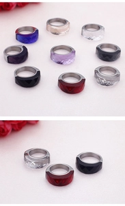 Macro view of wide stainless steel rings with colorful faceted glass stones in various colors