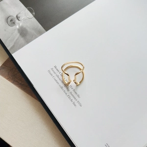 Detailed view of the gold abstract human profile face ring on a minimalist magazine