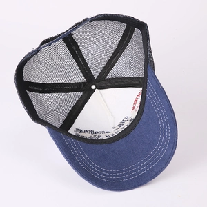 Deep blue trucker hat with breathable mesh and adjustable strap in a 45-degree angle view