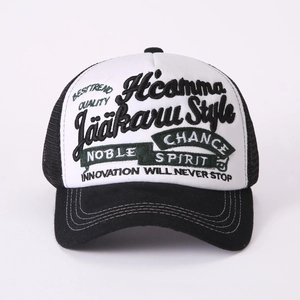 Detail of high-quality 3D embroidery on a black and white breathable mesh trucker hat