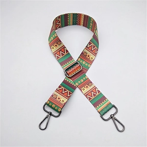 Adjustable ethnic style woven bag strap with green and red geometric patterns and metal hooks