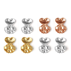 Macro view of heart-shaped earring lifters in silver, gold, and rose gold finishes