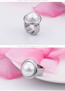 Close-up of wide silver stainless steel ring featuring a large white round pearl inlay
