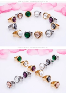 Detail view of colorful gemstone and pearl rings in gold and silver settings