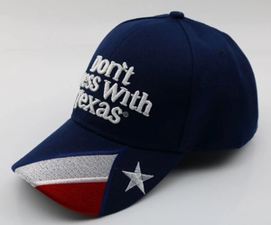 Detail of navy baseball cap featuring Don't Mess With Texas 3D embroidery and flag brim