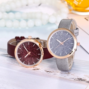 Detail of luxury glitter dial watches in burgundy and silver with rose gold cases