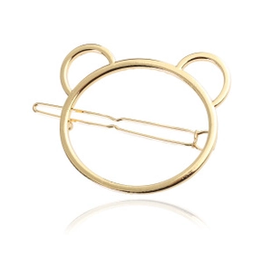 Detail of a minimalist gold metal hair clip featuring a cute hollow bear silhouette design