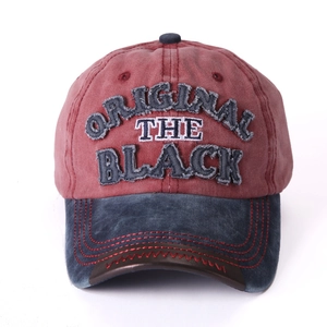Close-up of distressed vintage baseball cap with embroidered logo and contrast brim