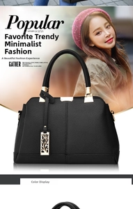 Close-up of black lychee grain leather handbag with gold hardware and logo pendant