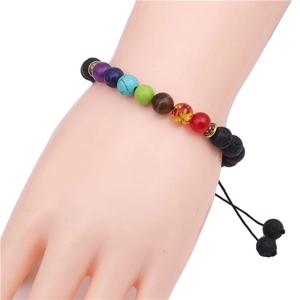 8mm lava stone chakra beaded bracelet with adjustable cord and golden spacers on wrist