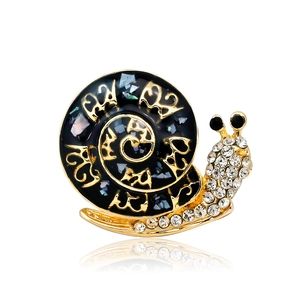 Vintage snail brooch in black enamel with golden lines and sparkling rhinestones