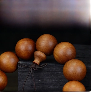 Macro detail of Indonesian sandalwood prayer beads showing rich natural wood grain texture