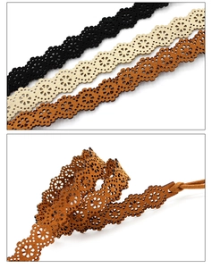 Detail of bohemian laser-cut waist belts with floral patterns in black, beige and brown