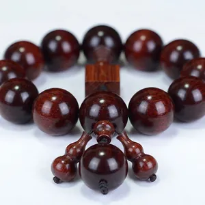 Polished dark red rhinoceros horn bead bracelet in a high-contrast elegant still life view