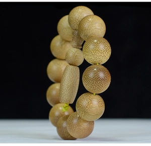 Macro shot of high-density dragon blood bamboo beads showing natural texture and patterns