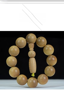 Macro view of dragon blood gold silk bamboo prayer beads with natural speckled grain texture