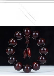 Macro shot of polished red sandalwood beads with natural grain and glossy finish
