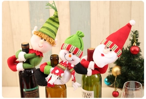 Close-up of Santa and snowman knitted wine bottle covers for Christmas home decor