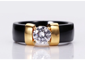 Macro shot of 6mm black ceramic ring with gold inlay and large round white zircon