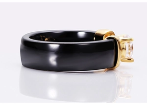Macro view of 6mm black ceramic ring with gold claw setting and large round zircon stone