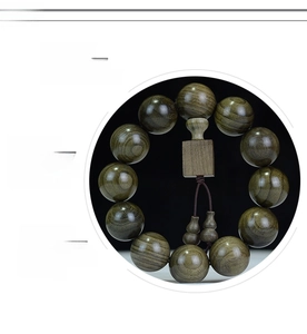 Close-up of polished natural Phoebe zhennan wood beads with unique grain and gourd charms