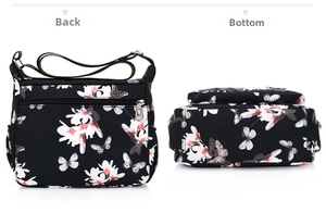 Detail view showing the back and bottom of the floral print nylon crossbody bag