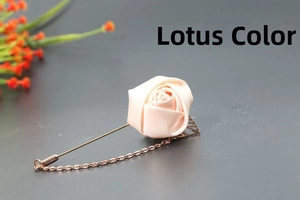 Detail of pale pink satin rose brooch with rose gold leaf and delicate chain