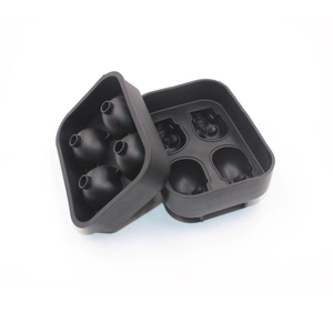 Detailed view of black silicone ice mold creating 4 large 3D skull shaped ice cubes